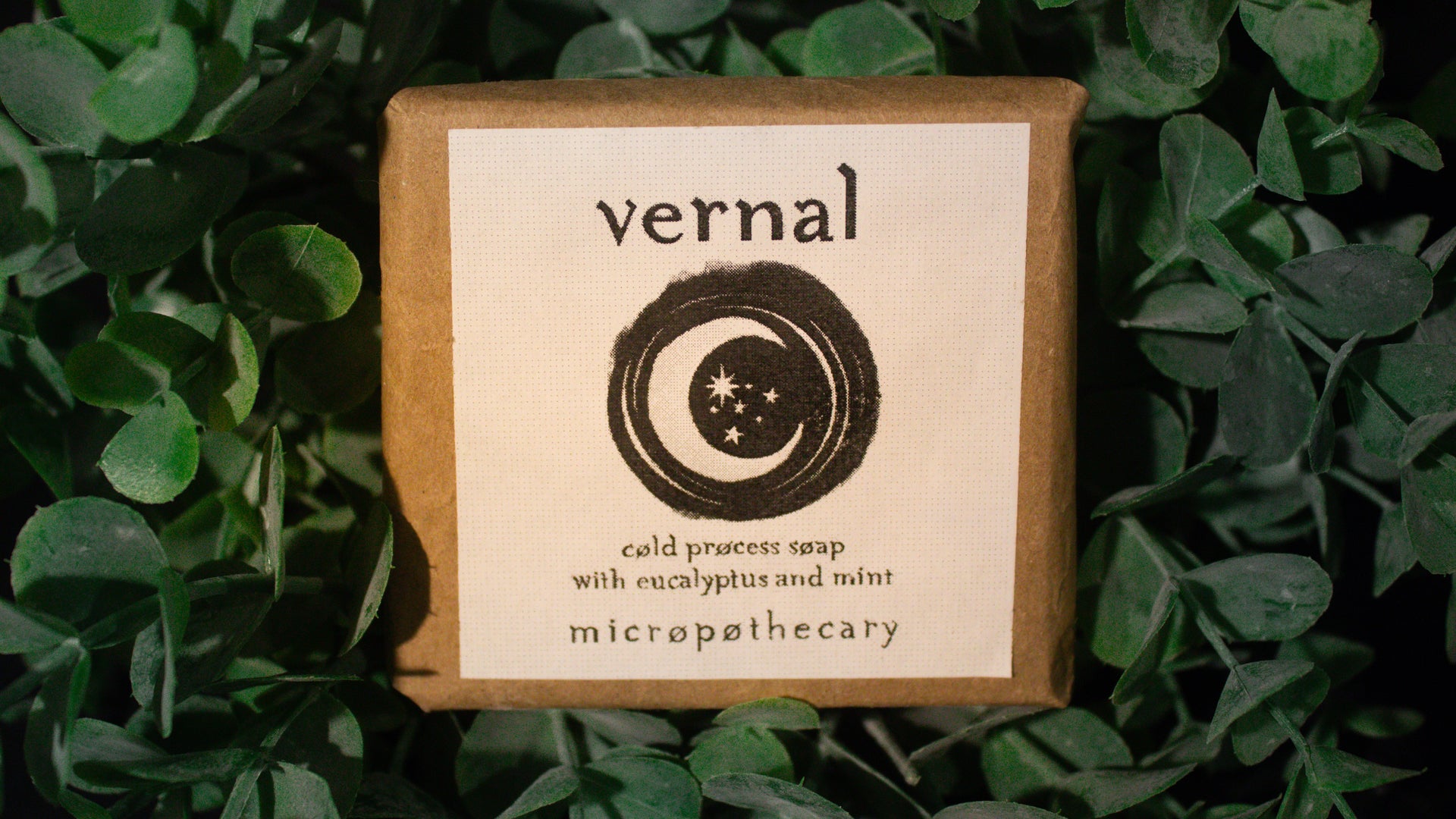 Vernal cold process soap bar with eucalyptus and mint label on green leaf background