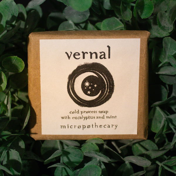 Vernal cold process soap bar with eucalyptus and mint label on green leaf background