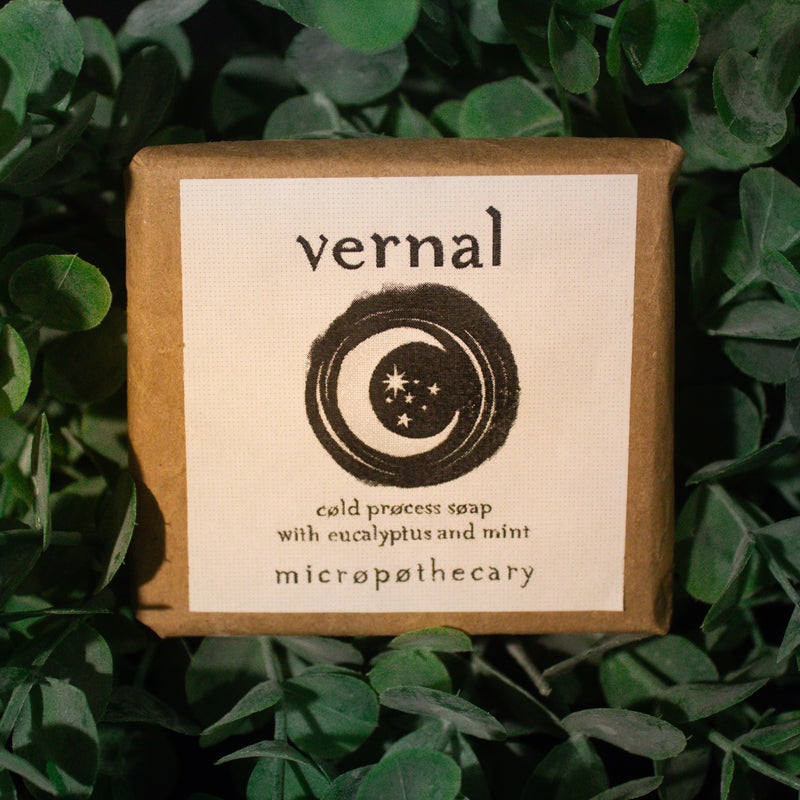 Vernal cold process soap bar with eucalyptus and mint label on green leaf background